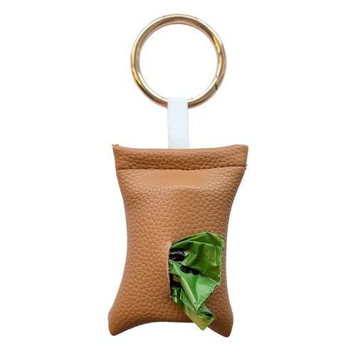 Camel color poop bag holder in vegan leather, handmade in Stockholm. The pouch features a metal ring and holds one roll of dog waste bags.