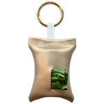 Gold color poop bag holder in vegan leather, handmade in Stockholm. The pouch features a metal ring and holds one roll of dog waste bags.